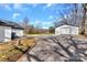 Spacious backyard with gravel driveway, detached garage, and plenty of room for outdoor activities at 606 N Elm St, Marshville, NC 28103