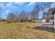 Large backyard with mature trees, a detached garage, and ample space for outdoor enjoyment at 606 N Elm St, Marshville, NC 28103