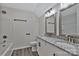 Well-lit bathroom with double vanity, granite countertop, framed mirrors, modern lighting and a shower and tub combo at 606 N Elm St, Marshville, NC 28103