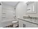 A bathroom featuring modern flooring, shower-tub combo, and granite vanity at 606 N Elm St, Marshville, NC 28103