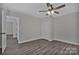 A bedroom featuring modern flooring, neutral walls, ceiling fan and closet at 606 N Elm St, Marshville, NC 28103