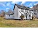 Classic white two-story home with black accents, well-maintained lawn, and mature landscaping at 606 N Elm St, Marshville, NC 28103