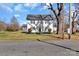 Traditional two-story home with fresh white siding, black shutters, and mature landscaping at 606 N Elm St, Marshville, NC 28103