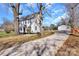 Charming two-story home with a long gravel driveway leading to a detached garage and mature shade trees at 606 N Elm St, Marshville, NC 28103
