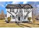 Charming two-story home featuring a gray roof, a black door and shutters, and a well-maintained front lawn at 606 N Elm St, Marshville, NC 28103
