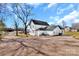 View of the two-story home, showcasing the rear addition, driveway, and spacious lot at 606 N Elm St, Marshville, NC 28103