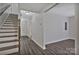 Hallway that leads to a living room area with wood-look floors and staircase at 606 N Elm St, Marshville, NC 28103