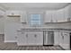 Bright kitchen featuring granite countertops, stainless steel appliances, and sleek white cabinets at 606 N Elm St, Marshville, NC 28103