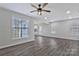 Spacious living room filled with natural light, featuring new gray flooring and a ceiling fan at 606 N Elm St, Marshville, NC 28103