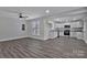 Open-concept living room and kitchen area with gray wood-look floors and bright white walls at 606 N Elm St, Marshville, NC 28103