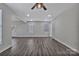 Spacious living room filled with natural light, featuring new gray flooring and a ceiling fan at 606 N Elm St, Marshville, NC 28103
