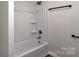 Modern bathroom featuring a clean, new tub and shower combination, and a simple towel bar at 606 N Elm St, Marshville, NC 28103