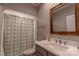 Bathroom featuring modern fixtures, a shower with a patterned curtain, and a framed mirror at 627 Birdie Ln # 21/22, Norwood, NC 28128