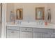 Bathroom featuring double sinks, wooden framed mirrors, and white quartz countertop at 627 Birdie Ln # 21/22, Norwood, NC 28128