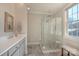 Modern bathroom with a glass enclosed shower, stone floors, and vanity with a framed mirror at 627 Birdie Ln # 21/22, Norwood, NC 28128