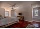 Comfortable bedroom with a ceiling fan, a television on a wooden stand, and natural light at 627 Birdie Ln # 21/22, Norwood, NC 28128