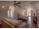 Loft-style bedroom with a comfortable couch, ceiling fan, and an abundance of natural light at 627 Birdie Ln # 21/22, Norwood, NC 28128