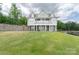 Beautiful lakefront home featuring a large lawn and multiple outdoor spaces at 627 Birdie Ln # 21/22, Norwood, NC 28128