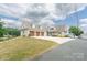 Charming home with a three-car garage and landscaped front yard on a waterfront lot at 627 Birdie Ln # 21/22, Norwood, NC 28128