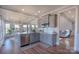 Stylish kitchen featuring gray cabinets, a breakfast bar, and views of the dining and living areas at 627 Birdie Ln # 21/22, Norwood, NC 28128