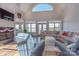 Sun-filled living room boasts fireplace, vaulted ceilings, and waterfront views at 627 Birdie Ln # 21/22, Norwood, NC 28128