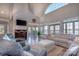 Bright living room with high ceilings, fireplace, and large windows showcasing waterfront views at 627 Birdie Ln # 21/22, Norwood, NC 28128