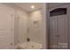 Clean shower with glass door, tiled walls, and built in shelving at 627 Birdie Ln # 21/22, Norwood, NC 28128