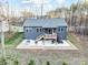 An aerial view of a home with a backyard patio, deck, and wooded area at 7595 Lakehaven Dr, Denver, NC 28037