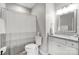 Well-lit bathroom with a shower and bathtub combination, white vanity, and a granite countertop at 7595 Lakehaven Dr, Denver, NC 28037