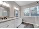 Elegant bathroom with double sinks, granite countertops, and natural light at 7595 Lakehaven Dr, Denver, NC 28037