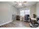 Cozy bedroom with a ceiling fan, hardwood flooring, and a window that lets in natural light at 7595 Lakehaven Dr, Denver, NC 28037