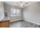 Comfortable bedroom with wood-look floors, a ceiling fan, and a window to the yard at 7595 Lakehaven Dr, Denver, NC 28037