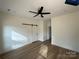 A bedroom featuring vinyl floors, ceiling fan and sliding barn door at 803 Fargo Dr, Concord, NC 28027