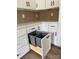 White kitchen cabinets feature a pull-out double trash can for convenience and organization at 803 Fargo Dr, Concord, NC 28027