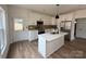 Modern kitchen featuring white cabinets, stainless steel appliances, and a central island at 803 Fargo Dr, Concord, NC 28027