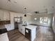 Modern kitchen with stainless steel appliances, white countertops, and open layout to the living area at 803 Fargo Dr, Concord, NC 28027