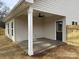 Covered back patio with ceiling fan, ideal for outdoor dining and relaxing, plus privacy fence at 803 Fargo Dr, Concord, NC 28027