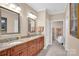 Lovely bathroom featuring double sink vanity, granite countertops, tile floors, and neutral walls at 8439 Sonata Ct, Denver, NC 28037