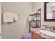 Bright bathroom with granite countertop, a wood cabinet, and a decorative towel rack above the toilet at 8439 Sonata Ct, Denver, NC 28037