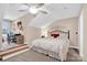 Well-lit bedroom featuring neutral walls, a ceiling fan, a comfortable-looking bed, and a desk area at 8439 Sonata Ct, Denver, NC 28037