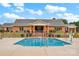 Inviting community pool area with brick building and lush landscaping, perfect for relaxation and recreation at 8439 Sonata Ct, Denver, NC 28037