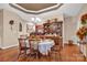 Elegant dining room featuring hardwood floors, a chandelier, and a view into the kitchen at 8439 Sonata Ct, Denver, NC 28037