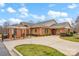 Charming brick building featuring a covered driveway, manicured landscaping, and ample parking at 8439 Sonata Ct, Denver, NC 28037