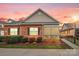 Brick home featuring a screened porch, neat landscaping, and an American flag; neighborhood view at 8439 Sonata Ct, Denver, NC 28037