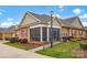 Charming brick home with a screened porch, ramp access, and beautifully landscaped yard at 8439 Sonata Ct, Denver, NC 28037