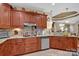 Well-equipped kitchen features granite counters, tile backsplash, stainless steel appliances, and ample wood cabinetry at 8439 Sonata Ct, Denver, NC 28037