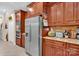 Updated kitchen with stainless steel refrigerator, granite countertops, wood cabinets, and modern appliances at 8439 Sonata Ct, Denver, NC 28037