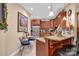 Charming kitchen featuring custom cabinets, granite countertops, and a breakfast bar with seating at 8439 Sonata Ct, Denver, NC 28037