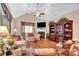 Cozy living room featuring hardwood floors, a fireplace, comfortable sofas, and natural light at 8439 Sonata Ct, Denver, NC 28037