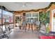 Relaxing screened porch featuring outdoor seating, charming decorations, and a view of the backyard at 8439 Sonata Ct, Denver, NC 28037